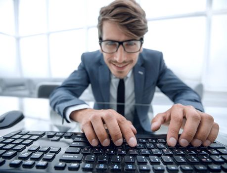 Funny and crazy man using a computer in the office background. man's hands on the keyboard