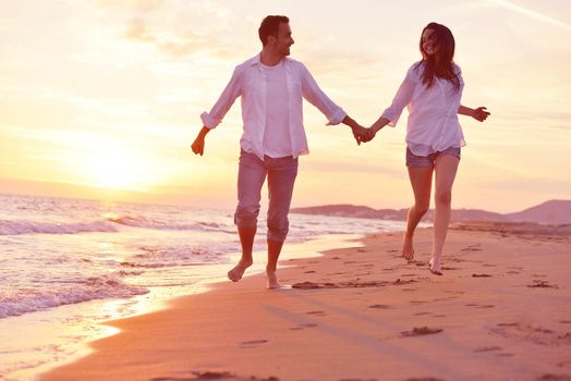 happy young romantic couple in love have fun on beautiful beach at beautiful summer day