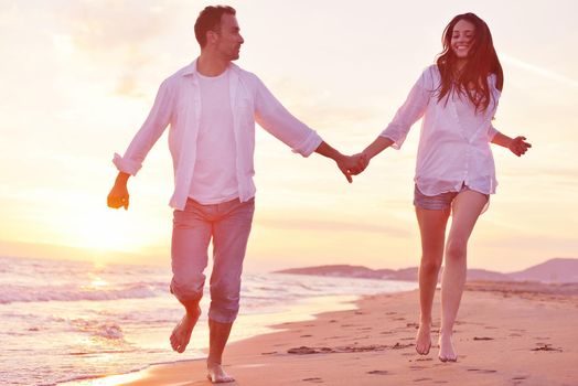 happy young romantic couple in love have fun on beautiful beach at beautiful summer day