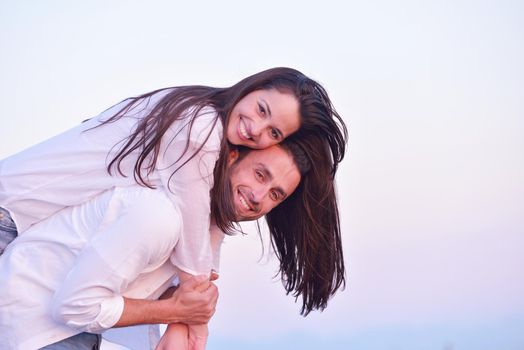 happy young romantic couple in love have fun on beautiful beach at beautiful summer day