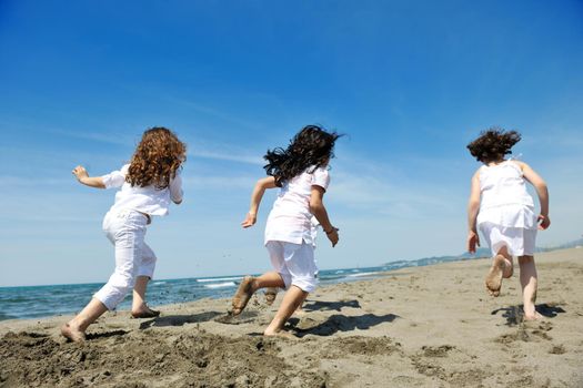 group of happy child on beach who have fun and play games