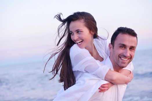 happy young romantic couple in love have fun on beautiful beach at beautiful summer day