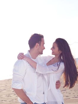 happy young romantic couple in love have fun on beautiful beach at beautiful summer day