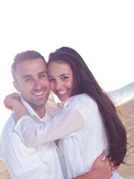 happy young romantic couple in love have fun on beautiful beach at beautiful summer day