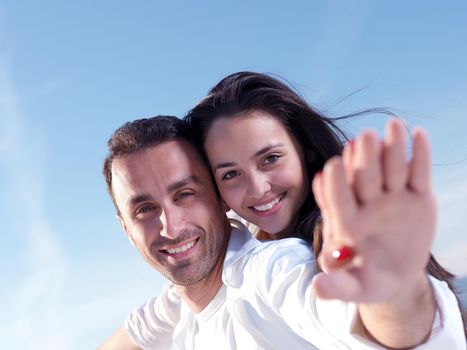 happy young romantic couple in love have fun on beautiful beach at beautiful summer day