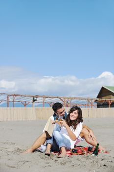 happy young couple enjoying  picnic on the beach and have good time on summer vacations