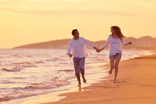 happy young romantic couple in love have fun on beautiful beach at beautiful summer day