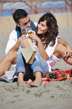 happy young couple enjoying  picnic on the beach and have good time on summer vacations