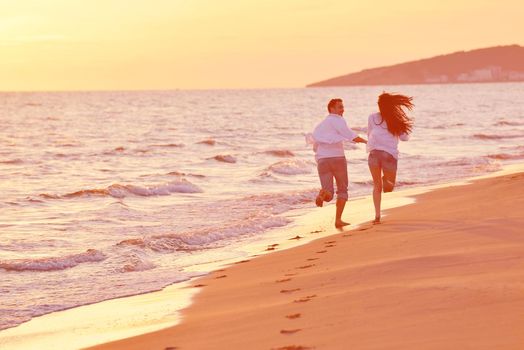 happy young romantic couple in love have fun on beautiful beach at beautiful summer day