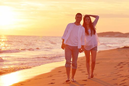 happy young romantic couple in love have fun on beautiful beach at beautiful summer day