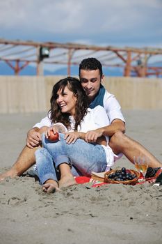 happy young couple enjoying  picnic on the beach and have good time on summer vacations