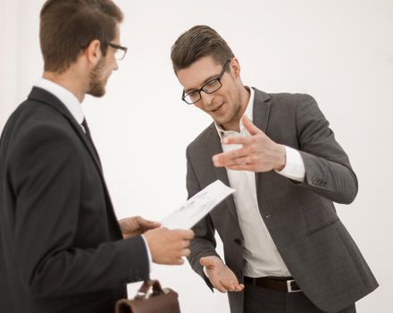 business colleagues discussing a working paper while standing in the office.business concept