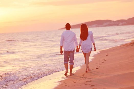 happy young romantic couple in love have fun on beautiful beach at beautiful summer day