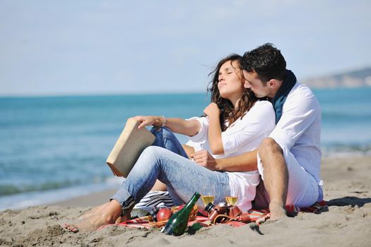 happy young couple enjoying  picnic on the beach and have good time on summer vacations