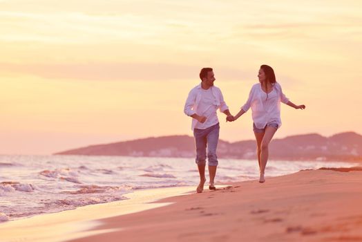 happy young romantic couple in love have fun on beautiful beach at beautiful summer day