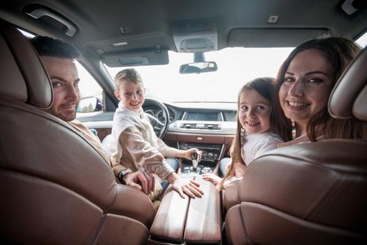 modern family sitting in a comfortable car. family holiday