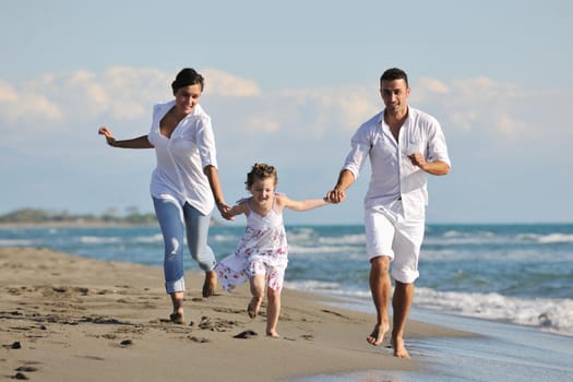 happy young family in white clothing have fun at vacations on beautiful beach 