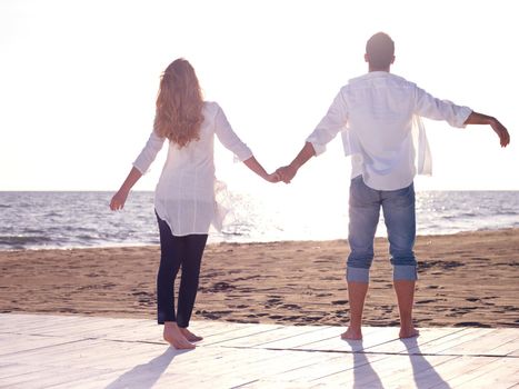 happy young romantic couple in love have fun on beautiful beach at beautiful summer day