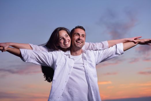 happy young romantic couple in love have fun on beautiful beach at beautiful summer day