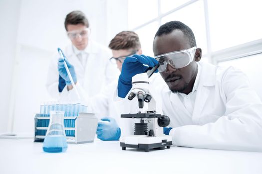 modern scientist looking through a microscope.photo with copy space