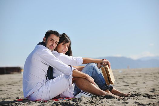 happy young couple enjoying  picnic on the beach and have good time on summer vacations