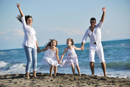 happy young family in white clothing have fun at vacations on beautiful beach 