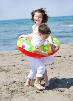 group of happy child on beach who have fun and play games