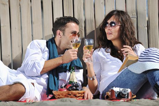 happy young couple enjoying  picnic on the beach and have good time on summer vacations