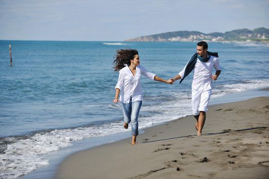 happy young couple in white clothing  have romantic recreation and   fun at beautiful beach on  vacations