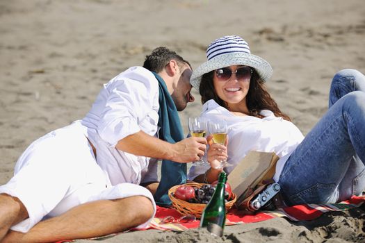 happy young couple enjoying  picnic on the beach and have good time on summer vacations