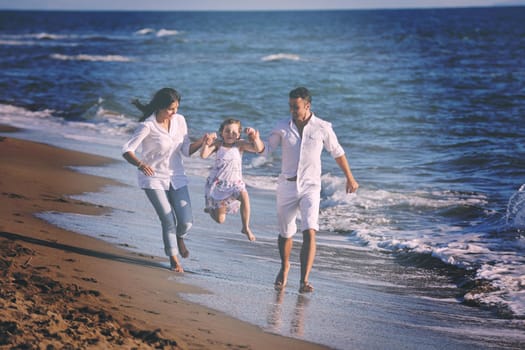 happy young family in white clothing have fun at vacations on beautiful beach 