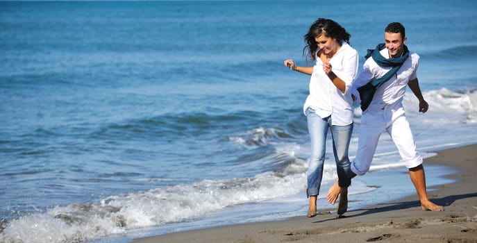 happy young couple in white clothing  have romantic recreation and   fun at beautiful beach on  vacations