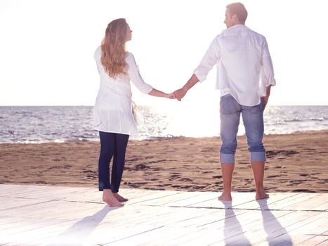 happy young romantic couple in love have fun on beautiful beach at beautiful summer day