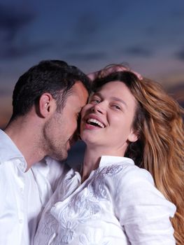 happy young romantic couple in love have fun on beautiful beach at beautiful summer day