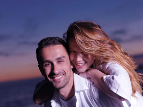 happy young romantic couple in love have fun on beautiful beach at beautiful summer day