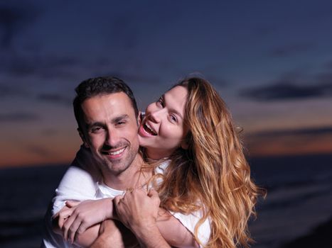 happy young romantic couple in love have fun on beautiful beach at beautiful summer day