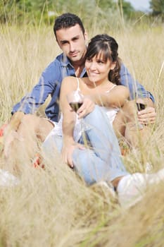 happy young couple enjoying  picnic on the countryside in the field  and have good time