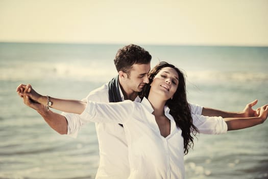 happy young couple in white clothing  have romantic recreation and   fun at beautiful beach on  vacations