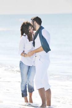 happy young couple in white clothing  have romantic recreation and   fun at beautiful beach on  vacations