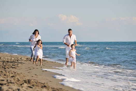 happy young family in white clothing have fun at vacations on beautiful beach 