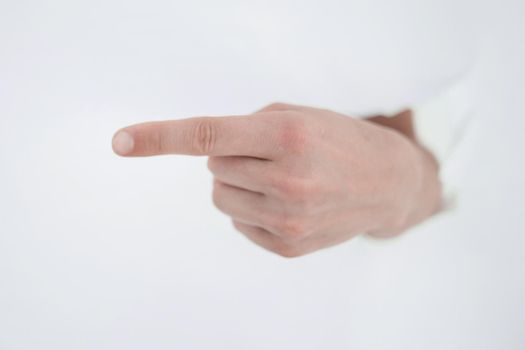 man's hand breaking through the paper wall and pointing at you .photo with copy space