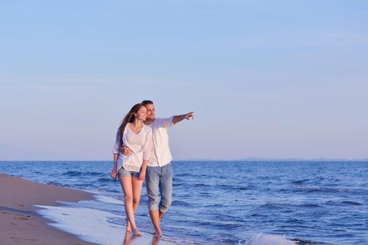 happy young romantic couple in love have fun on beautiful beach at beautiful summer day