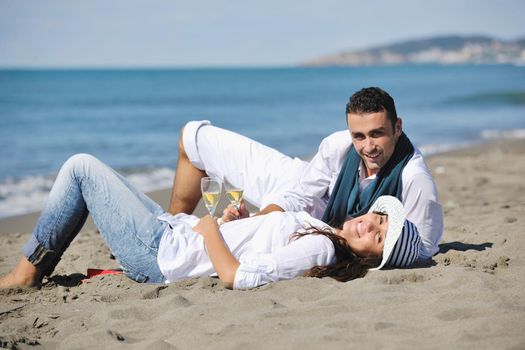 happy young couple enjoying  picnic on the beach and have good time on summer vacations