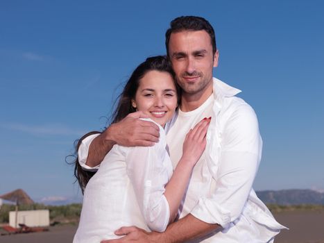 happy young romantic couple in love have fun on beautiful beach at beautiful summer day