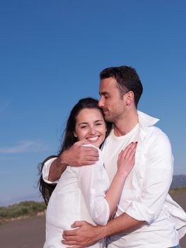 happy young romantic couple in love have fun on beautiful beach at beautiful summer day