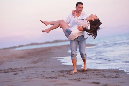 happy young romantic couple in love have fun on beautiful beach at beautiful summer day