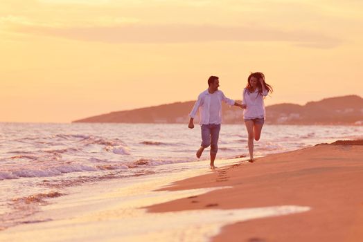 happy young romantic couple in love have fun on beautiful beach at beautiful summer day