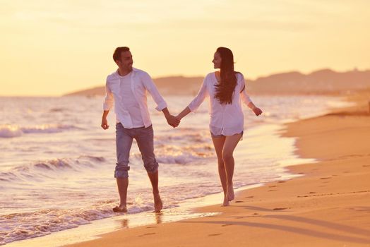 happy young romantic couple in love have fun on beautiful beach at beautiful summer day