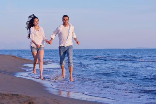 happy young romantic couple in love have fun on beautiful beach at beautiful summer day