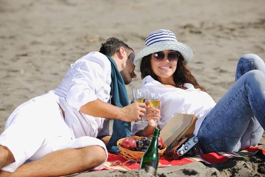 happy young couple enjoying  picnic on the beach and have good time on summer vacations